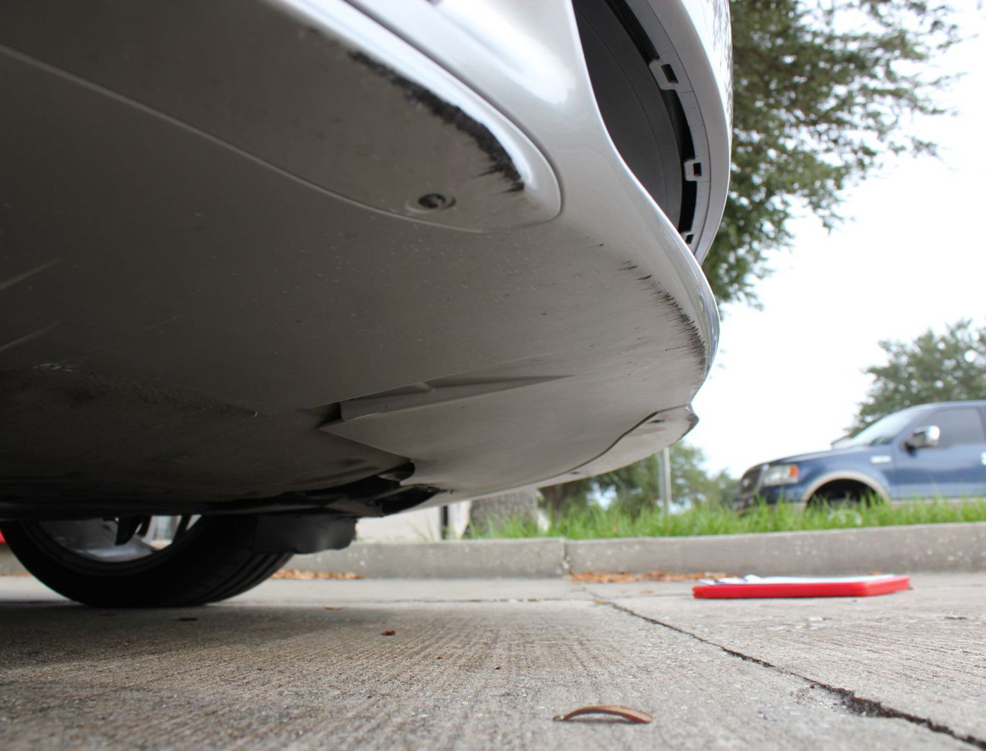 (Sample) From a previous inspection of a 2009 Porsche Cayman noting scrapes on the bumper